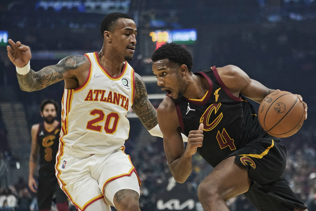 Cleveland Cavaliers' Evan Mobley (4) drives against Atlanta Hawks' John Collins (20) in the first h...