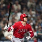 
              Los Angeles Angels' Shohei Ohtani watches the path of his fly out against the Seattle Mariners in the third inning of a baseball game Saturday, Oct. 2, 2021, in Seattle. (AP Photo/Elaine Thompson)
            