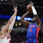 
              Detroit Pistons forward Jerami Grant, right, shoots over Chicago Bulls center Nikola Vucevic during the first half of an NBA basketball game in Chicago, Saturday, Oct. 23, 2021. (AP Photo/Nam Y. Huh)
            