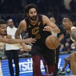 
              Cleveland Cavaliers' Ricky Rubio, center, drives between Atlanta Hawks' Trae Young, left, and John Collins in the first half of an NBA basketball game, Saturday, Oct. 23, 2021, in Cleveland. (AP Photo/Tony Dejak)
            