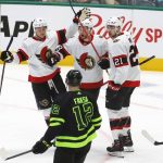 
              Ottawa Senators' Connor Brown, top center, is congratulated by Tim Stützle (18) and Nick Paul (21) after his goal, as Dallas Stars center Radek Faksa (12) watches during the third period of an NHL hockey game Friday, Oct. 29, 2021, in Dallas. (AP Photo/Ray Carlin)
            
