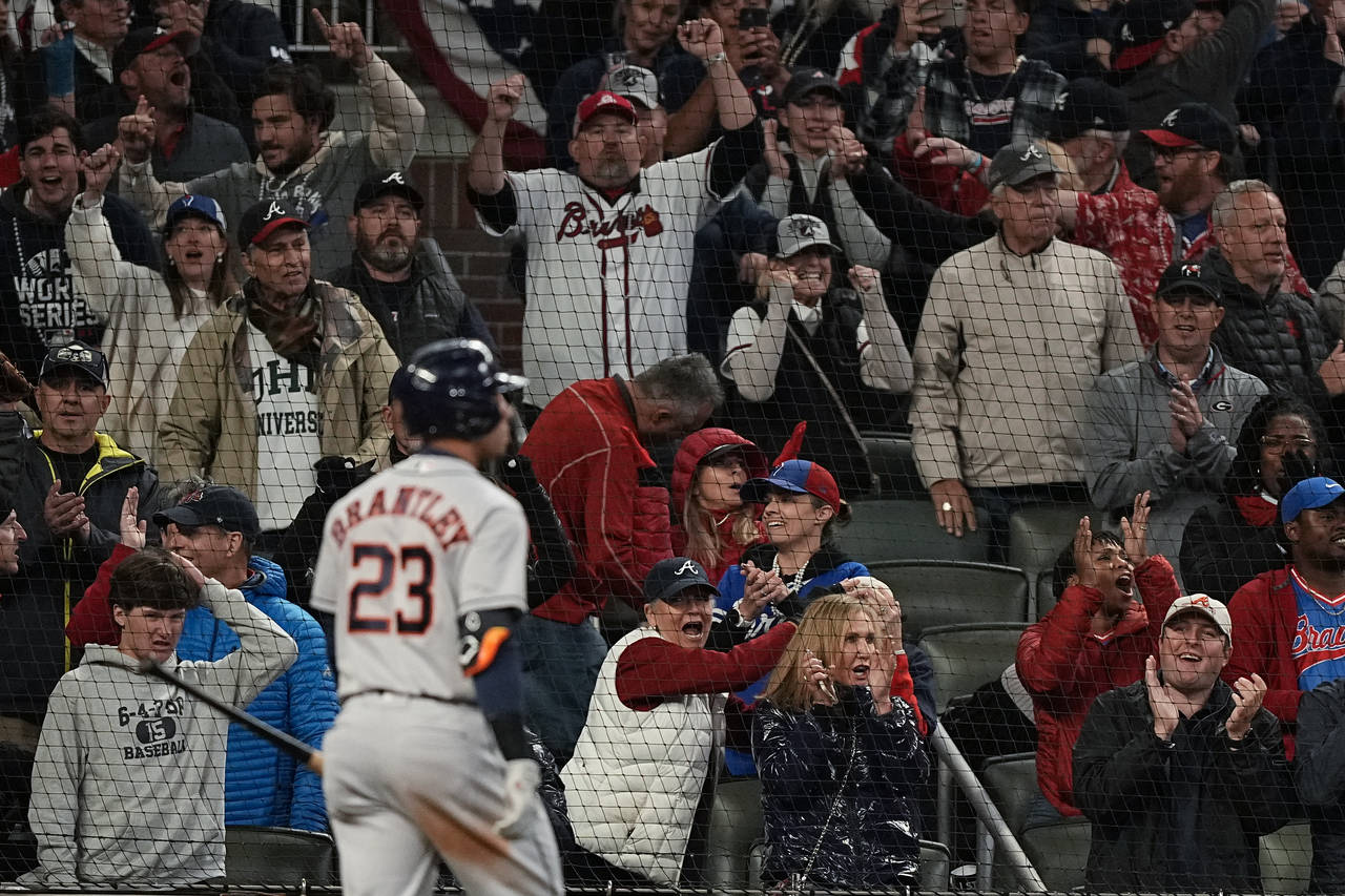 Fans cheer after Houston Astros' Michael Brantley strikes out for the last out during the ninth inn...