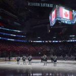 
              Seattle Kraken and Vancouver Canucks players stand during the Canadian national anthem before an NHL hockey game Saturday, Oct. 23, 2021, in Seattle. (AP Photo/Ted S. Warren)
            