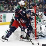 
              Columbus Blue Jackets' Jakub Voracek, front, tries to shoot against Dallas Stars' Braden Holtby, right, as Stars' Jamie Benn defends during the second period of an NHL hockey game Monday, Oct. 25, 2021, in Columbus, Ohio. (AP Photo/Jay LaPrete)
            