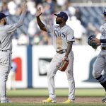 
              Tampa Bay Rays right fielder Manuel Margot high-fives second baseman Brandon Lowe (8) after defeating the New York Yankees in a baseball game on Saturday, Oct. 2, 2021, in New York. The Rays won 12-2. (AP Photo/Adam Hunger)
            