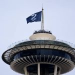 
              A Seattle Kraken hockey team flag flies atop the Space Needle on Saturday afternoon, Oct. 23, 2021, in Seattle, before the Kraken's inaugural home match as the newest NHL team, against the Vancouver Canucks later Saturday. (AP Photo/Elaine Thompson)
            