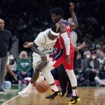 
              Washington Wizards guard Aaron Holiday, right, fouls Boston Celtics guard Dennis Schroder (71) during the first half of an NBA basketball game, Wednesday, Oct. 27, 2021, in Boston. (AP Photo/Charles Krupa)
            