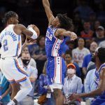 
              Oklahoma City Thunder guard Shai Gilgeous-Alexander (2) tries to pass the ball around Philadelphia 76ers guard Tyrese Maxey, center, and center Joel Embiid, right, in the first half of an NBA basketball game Sunday, Oct. 24, 2021, in Oklahoma City. (AP Photo/Nate Billings)
            
