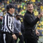 
              Oregon head coach Mario Cristobal, right, talks with an official during the second quarter of an NCAA college football game against Colorado, Saturday, Oct. 30, 2021, in Eugene, Ore. (AP Photo/Andy Nelson)
            