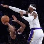 
              Houston Rockets guard Eric Gordon, left, shoots as Los Angeles Lakers forward Carmelo Anthony defends during the first half of an NBA basketball game Sunday, Oct. 31, 2021, in Los Angeles. (AP Photo/Mark J. Terrill)
            
