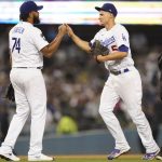 
              Los Angeles Dodgers relief pitcher Kenley Jansen (74) and shortstop Corey Seager (5) celebrate an 8-6 win over the Milwaukee Brewers after their a baseball game Friday, Sept. 1, 2021, in Los Angeles. (AP Photo/Ashley Landis)
            