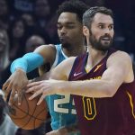 
              Charlotte Hornets' P.J. Washington (25) knocks the ball loose from Cleveland Cavaliers' Kevin Love (0) in the first half of an NBA basketball game, Friday, Oct. 22, 2021, in Cleveland. (AP Photo/Tony Dejak)
            