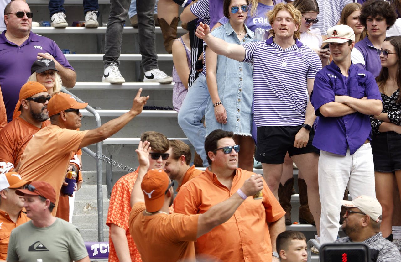 Texas and TCU fans let their feelings show during the second half of an NCAA college football game ...