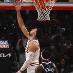 
              Chicago Bulls guard Zach LaVine, top, scores against Utah Jazz forward Royce O'Neale (23) during the first half of an NBA basketball game Saturday, Oct. 30, 2021, in Chicago. (AP Photo/Matt Marton)
            