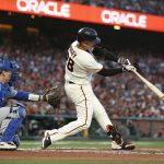 
              San Francisco Giants' Buster Posey hits a double in front of Los Angeles Dodgers catcher Will Smith during the first inning of Game 5 of a baseball National League Division Series Thursday, Oct. 14, 2021, in San Francisco. (AP Photo/Jed Jacobsohn)
            