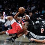 
              Washington Wizards' Bradley Beal (3) shoots over Brooklyn Nets' Blake Griffin (2) while falling down during the first half of an NBA basketball game Monday, Oct. 25, 2021, in New York. (AP Photo/Frank Franklin II)
            