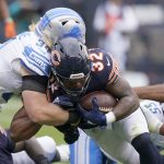 
              Chicago Bears running back David Montgomery (32) scores as Detroit Lions middle linebacker Alex Anzalone defends during the first half of an NFL football game Sunday, Oct. 3, 2021, in Chicago. (AP Photo/Nam Y. Huh)
            