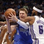 
              Dallas Mavericks guard Luka Doncic (77) is fouled by Sacramento Kings forward Maurice Harkless (8) during the first half of an NBA basketball game in Dallas, Sunday, Oct. 31, 2021. (AP Photo/Michael Ainsworth)
            