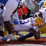 
              LSU running back Tyrion Davis-Price (3) follows the block of guard Ed Ingram (70) and dives into the end zone for a touchdown during the first half of an NCAA college football game against Mississippi in Oxford, Miss., Saturday, Oct. 23, 2021. (AP Photo/Rogelio V. Solis)
            