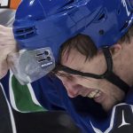 
              Vancouver Canucks' Luke Schenn has his visor pulled by Philadelphia Flyers' Zack MacEwen as they fight during the second period of an NHL hockey game Thursday, Oct. 28, 2021, in Vancouver, British Columbia. (Darryl Dyck/The Canadian Press via AP)
            