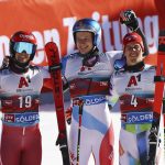 
              Winner Switzerland's Marco Odermatt, center, is flanked by second placed Austria's Roland Leitinger, left and Slovenia's Zan Kranjec on the podium after an alpine ski, men's World Cup giant slalom, in Soelden, Austria, Sunday, Oct. 24, 2021. (AP Photo/Marco Trovati)
            