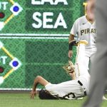 
              Pittsburgh Pirates' Cole Tucker (3) makes a diving catch for an out in the seventh inning against the Cincinnati Reds during a baseball game in Pittsburgh, Friday, Oct. 1, 2021. (AP Photo/Philip G. Pavely)
            