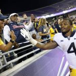 
              West Virginia running back Leddie Brown (4) celebrates with fans following a win over TCU in an NCAA college football game Saturday, Oct. 23, 2021, in Fort Worth, Texas. AP Photo/Ron Jenkins)
            