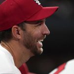
              St. Louis Cardinals' Adam Wainwright smiles in the dugout during the third inning of a baseball game against the Chicago Cubs Friday, Oct. 1, 2021, in St. Louis. (AP Photo/Jeff Roberson)
            
