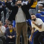 
              Injured Golden State Warriors guard Klay Thompson celebrates after a teammate scored against the Memphis Grizzlies during the first half of an NBA basketball game in San Francisco, Thursday, Oct. 28, 2021. (AP Photo/Jeff Chiu)
            