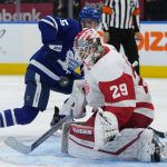 
              Detroit Red Wings goaltender Thomas Greiss (29) makes a save against Toronto Maple Leafs forward Alexander Kerfoot (15) during second-period NHL hockey game action in Toronto, Saturday, Oct. 30, 2021. (Nathan Denette/The Canadian Press via AP)
            