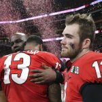 
              FILE- In this Jan. 8, 2018, file photo, Georgia's Jake Fromm and Jonathan Ledbetter reacts after their overtime lose to Alabama in College Football Playoff National Championship game in Atlanta. As the World Series comes to Atlanta for the first time since 1999, there is hope that the city — once immortalized by Sports Illustrated as “Loserville” — and the entire state of Georgia, for that matter, could be taking a turn toward some long-overdue parades and celebrations.  (Curtis Compton/Atlanta Journal-Constitution via AP, File)
            