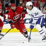 
              Toronto Maple Leafs' Auston Matthews (34) is pressured by Carolina Hurricanes' Derek Stepan (18) during the second period of an NHL hockey game in Raleigh, N.C., Monday, Oct. 25, 2021. (AP Photo/Karl B DeBlaker)
            