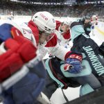 
              Montreal Canadiens defenseman Alexander Romanov (27) knocks down Seattle Kraken center Calle Jarnkrok (19) during the third period of an NHL hockey game, Tuesday, Oct. 26, 2021, in Seattle. The Kraken won 5-1. (AP Photo/Ted S. Warren)
            