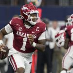 
              Arkansas quarterback KJ Jefferson scrambles out of the pocket before throwing a pass in the second half of an NCAA college football game against Texas A&M in Arlington, Texas, Saturday, Sept. 25, 2021. (AP Photo/Tony Gutierrez)
            