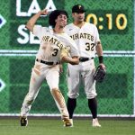 
              Pittsburgh Pirates' Cole Tucker (3) throws out Cincinnati Reds' Eugenio Suarez as right fielder Yoshi Tsutsugo (32) looks on during a baseball game in Pittsburgh, Friday, Oct. 1, 2021. Tucker caught the ball and threw out the runner to complete the double play. (AP Photo/Philip G. Pavely)
            