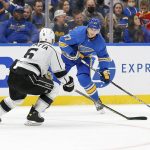 
              St. Louis Blues' Klim Kostin (37) handles the puck while under pressure from Los Angeles Kings' Olli Maatta (6) during the second period of an NHL hockey game Saturday, Oct. 23, 2021, in St. Louis. (AP Photo/Scott Kane)
            