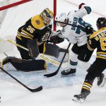 
              San Jose Sharks' Jonathan Dahlen (76) and Boston Bruins' Brad Marchand (63) battle for control of the puck in front of Bruins goaltender Linus Ullmark (35) during the third period of an NHL hockey game, Sunday, Oct. 24, 2021, in Boston. (AP Photo/Michael Dwyer)
            