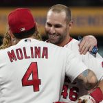 
              St. Louis Cardinals' Paul Goldschmidt, right, gets a hug from teammate Yadier Molina (4) after hitting a walk-off single to defeat the Chicago Cubs in a baseball game Friday, Oct. 1, 2021, in St. Louis. (AP Photo/Jeff Roberson)
            