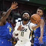 
              Utah Jazz guard Mike Conley (11) goes to the basket as Denver Nuggets Jeff Green (32) defends in the second half during an NBA basketball game Tuesday, Oct. 26, 2021, in Salt Lake City. (AP Photo/Rick Bowmer)
            