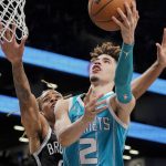 
              Charlotte Hornets guard LaMelo Ball (2) shoots against Brooklyn Nets forward Nic Claxton, left, during the first half of an NBA basketball game, Sunday, Oct. 24, 2021, in New York. (AP Photo/John Minchillo)
            