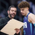 
              Charlotte Hornets head coach James Borrego, left, talks with guard LaMelo Ball, right, before an NBA basketball game against the Boston Celtics in Charlotte, N.C., Monday, Oct. 25, 2021. (AP Photo/Jacob Kupferman)
            
