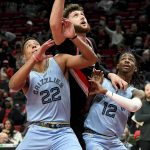 
              Portland Trail Blazers center Jusuf Nurkic, center, Memphis Grizzlies guard Desmond Bane, left, and guard Ja Morant, right, battle for position under the basket during the first half of an NBA basketball game in Portland, Ore., Wednesday, Oct. 27, 2021. (AP Photo/Steve Dykes)
            