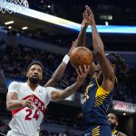 
              Toronto Raptors center Khem Birch (24) shoots under Indiana Pacers center Myles Turner (33) during the first half of an NBA basketball game in Indianapolis, Saturday, Oct. 30, 2021. (AP Photo/Michael Conroy)
            