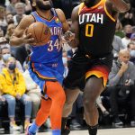 
              Oklahoma City Thunder forward Kenrich Williams (34) drives as Utah Jazz forward Eric Paschall (0) defends during the first half of an NBA basketball game Wednesday, Oct. 20, 2021, in Salt Lake City. (AP Photo/Rick Bowmer)
            