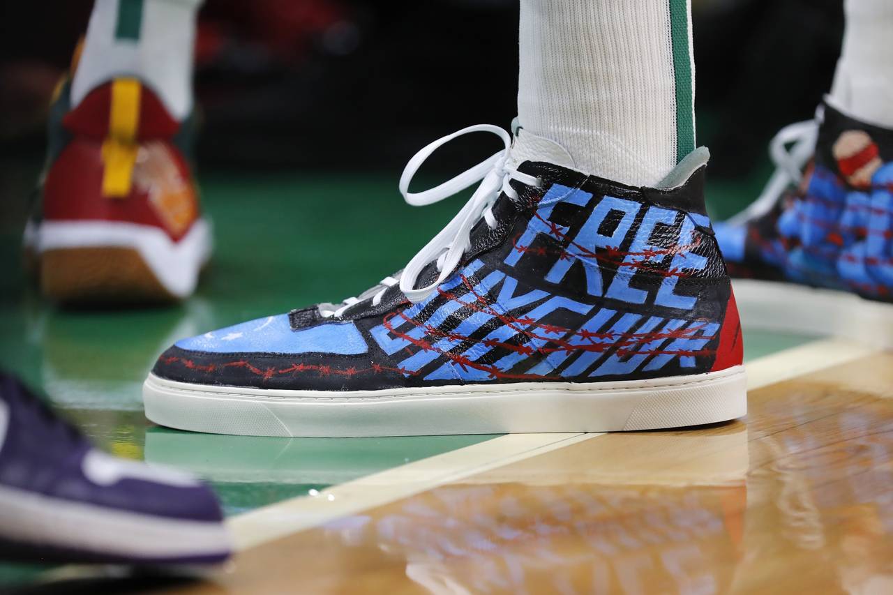 Boston Celtics' Enes Kanter wears shoes with a political message during the first half of an NBA ba...