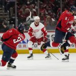 
              Washington Capitals left wing Alex Ovechkin (8) jumps over a shot by Washington Capitals defenseman Nick Jensen (3) in the first period of an NHL hockey game against the Detroit Red Wings, Wednesday, Oct. 27, 2021, in Washington. (AP Photo/Alex Brandon)
            