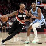 
              Portland Trail Blazers guard Damian Lillard, left, drives to the basket on Memphis Grizzlies guard De'Anthony Melton, right, during the first half of an NBA basketball game in Portland, Ore., Wednesday, Oct. 27, 2021. (AP Photo/Steve Dykes)
            