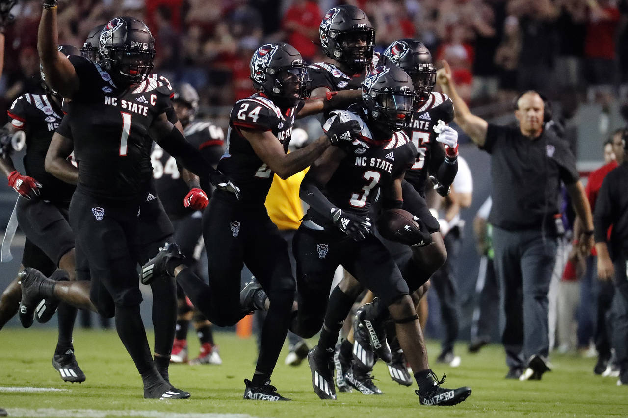 North Carolina State players celebrate an interception by Aydan White (3) during the first half of ...