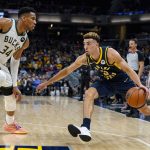 
              Indiana Pacers guard Chris Duarte (3) drives against Milwaukee Bucks forward Giannis Antetokounmpo (34) during the first half of an NBA basketball game in Indianapolis, Monday, Oct. 25, 2021. (AP Photo/Michael Conroy)
            