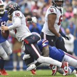 
              Houston Texans quarterback Davis Mills (10) is sacked by Buffalo Bills defensive end Boogie Basham (96) during the first half of an NFL football game, Sunday, Oct. 3, 2021, in Orchard Park, N.Y. (AP Photo/Adrian Kraus)
            